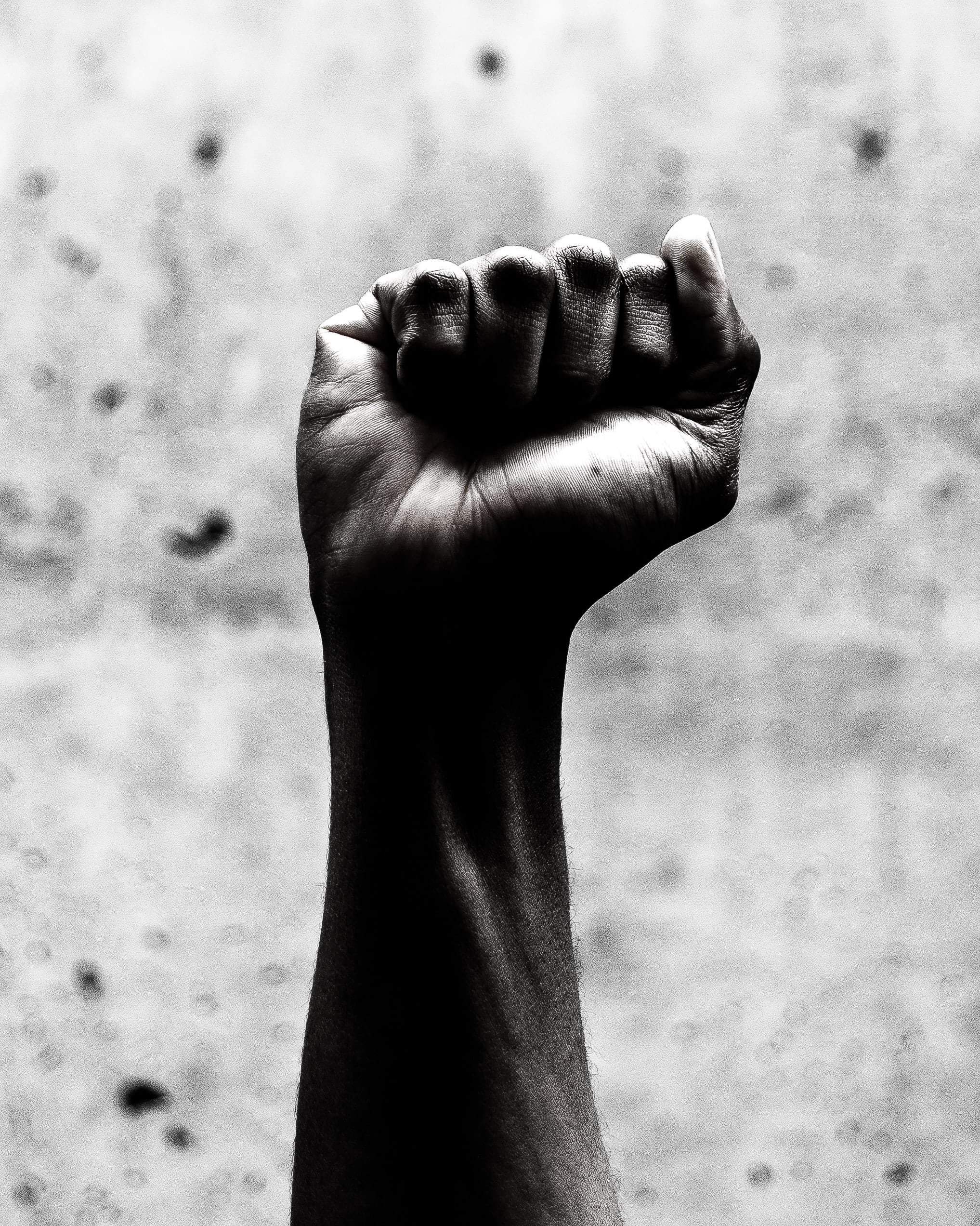 Black and white photo of a closed fist in the air